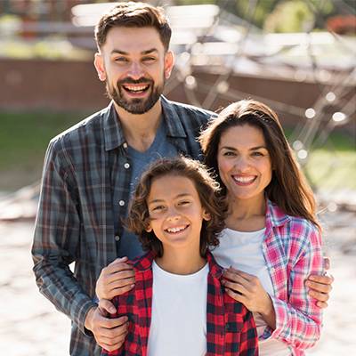 Happy Parents With Child Outside Their New Home in Texas